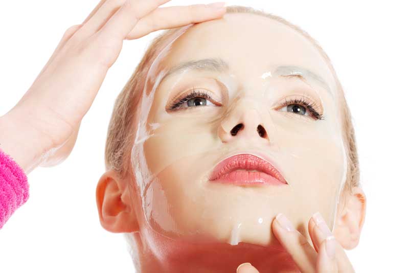 woman with a sheet mask on her face