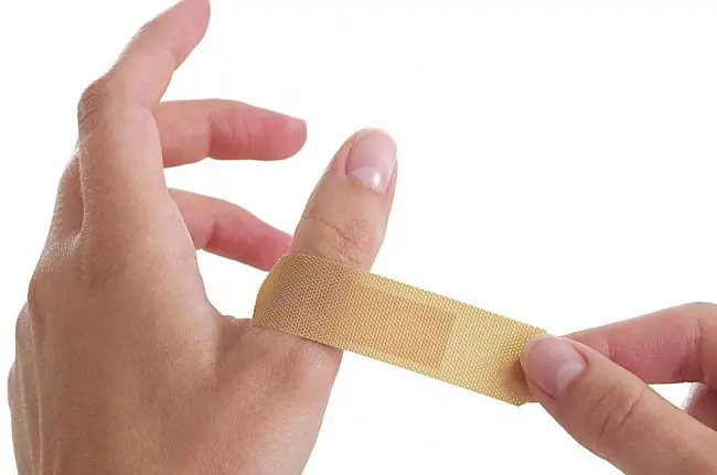 puttin a band aid on wound