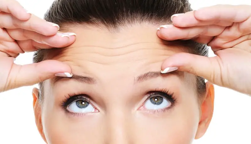 woman pinching frown lines