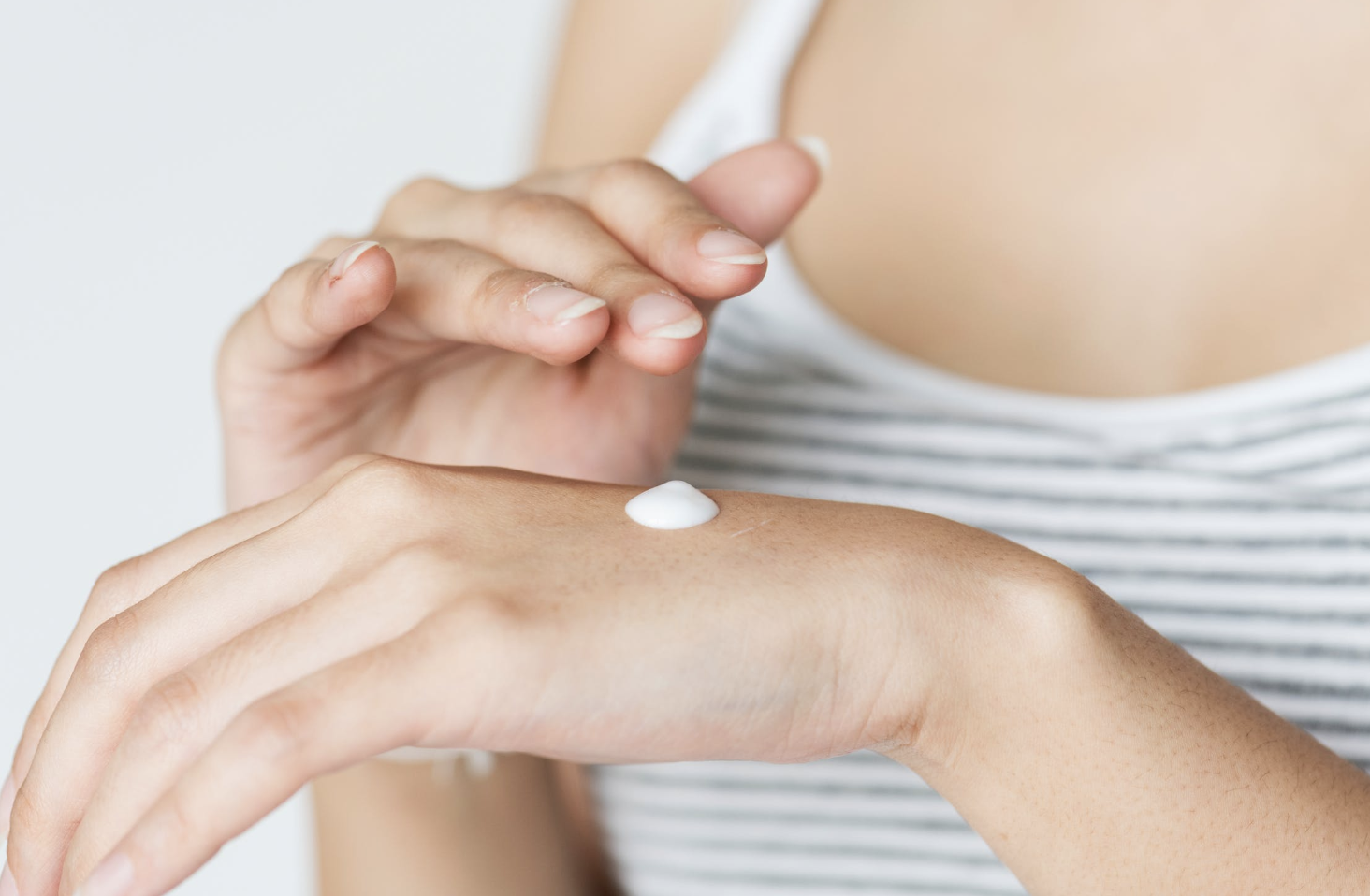 putting cream on the hand